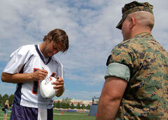 Plummer signs a football at Broncos training camp in 2006.