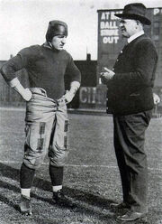 A coach conversing with a football player