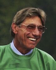 A man wearing glasses in a green shirt.