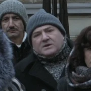 FAM 402 50.01 Crowd at newsstand - middle-aged man