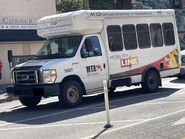 The 2015-2019 Ford E-350 Cutaway Van Exterior shown in Oxford White equipped with the High-Series Exterior Upgrade package with a Front Bumper Delete, a Passenger Side Door Deleted and 16" x 7" White-Painted Steel Wheels used on Coach and Equipment Phoenix ML Shuttle Wheelchair-Equipped Shuttle Buses