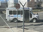 The 2023 Ford E-350 Cutaway Van Exterior Shown in Oxford White equipped with the High-Series Package with a Passenger Side Door Deleted and 16" x 7" White-Painted Steel Wheels used on Coach and Equipment Phoenix ML Shuttle Buses