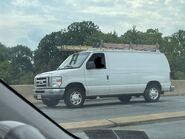 The 2014 Ford E-350 Cargo Van Exterior Shown in Oxford White equipped with the High-Series Exterior Upgrade Package with A Sliding Passenger Side Door, Rear Swing Out Cargo Doors and 16" Steel Wheels with Sport Wheel Covers