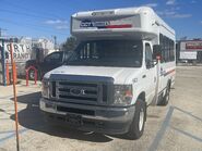 The 2024 Ford E-350 138" Single-Rear Wheelbase Cutaway Van Exterior Shown in Oxford White equipped with the High-Series Package with a Passenger Side Door Deleted and 16" x 7" White-Painted Steel Wheels used on Coach and Equipment Phoenix ML Wheelchair-equipped Shuttle Buses