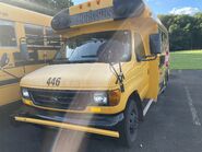 The 2006 Ford E-350 138" Dual-Rear Wheelbase Cutaway Van Exterior shown in School Bus Yellow with a Passenger Side Door Deleted and 16" x 6" White-Painted Steel Wheels used on Collins CSD-7450-F School Buses