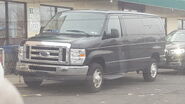 The 2008-2014 Ford E-350 XLT Passenger Van Exterior Shown in Black with a Sliding Passenger Side Door and 16" Steel Wheels with Sport Wheel Covers
