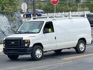 The 2009-2013 Ford E-350 Cargo Van Exterior Shown in Oxford White with Swing Out Passenger Side Cargo Doors, Rear Swing Out Windowed Cargo Doors and 16" Steel Wheels with Sport Wheel Covers