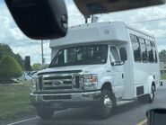 The 2019 Ford E-350 158" Dual-Rear Wheelbase Cutaway Van Exterior shown in Oxford White equipped with the High-Series Exterior Upgrade package with a Passenger Side Door Deleted and 16" x 6" Stainless Steel Wheel Covers used on Elkhart Coach ECII Wheelchair-equipped Shuttle Buses