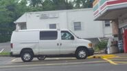 The 2003-2005 Ford E-350 Cargo Van Exterior Shown in Oxford White with A Sliding Windowed Passenger Side Door, 16” Steel Wheels with Sport Wheel Covers and Rear Swing Out Windowed Cargo Doors