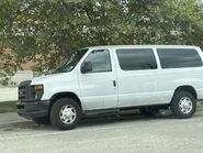 The 2009-2013 Ford E-350 XL Passenger Van Exterior Shown in Oxford White with A Sliding Passenger Side Door, Rear Swing Out Cargo Doors and 16" Steel Wheels with Full Sport Wheel Covers