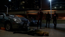 The Flash, Firestorm, and The Arrow stand over a defeated Reverse-Flash