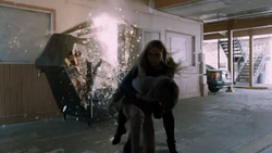 Lauren shielding Andy from the exploding vending machine