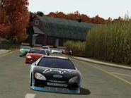 The 2002 Ford Taurus Stock Car leads the racers out of the corn field.