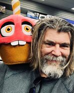 Christian Stokes with the 16” Mr. Cupcake Funko Plush.