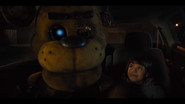 Abby in the back of a Taxi with Golden Freddy.