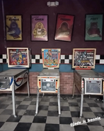 Pinball machines with posters of the band.