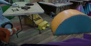 A deactivated Caution Bot lying on the floor of Daycare Attendant's Room.
