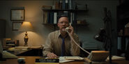"Steve Raglan" sitting at his desk on a call with Mike.