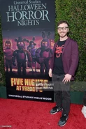 Kellen at Halloween Horror Nights in front of the Five Nights at Freddy's banner.