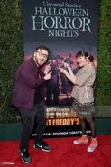 Kellen and Piper at Halloween Horror Nights in front of the Five Nights at Freddy's banner.