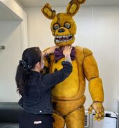 Matthew being suited into the Yellow Rabbit suit.