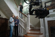A photo of Elizabeth Lail, Emma Tammi, and Matthew Lillard preparing for a scene in FNaF 2.