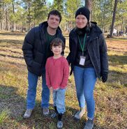 Josh, Emma, and Lucas in the forest.
