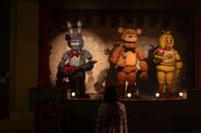Abby staring at the deactivated animatronics.
