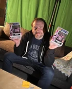 Scott holding signed Funko POP!'s on the set of Five Nights at Freddy's.
