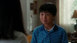 Evan wears a puka shell necklace