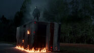 Jason Voorhees standing on top of the destroyed RV.