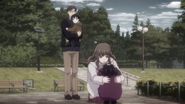 Saki being comforted by her parents as a child