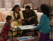 Teddy and his family playing Monopoly