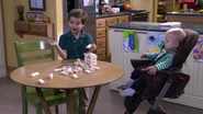 Max lets Tommy Jr. win his first game of Jenga.