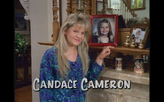 D.J. (Candace) posing by an old picture of herself in the living room