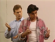 Jesse explains to the girls how he would fix a hole in a wall while Joey mimics his gestures behind him