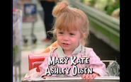 Michelle eating in a shopping cart in the supermarket