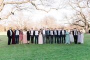 The Duggar children lined up in age order, including Tyler. It is spring and everyone is in formal clothing as it was taken at Jedidiah's wedding