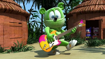 Gummibär plays his Guitar in the tribe village.
