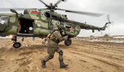 Belarusian soldier departing from a helicopter.
