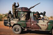 Malian soldiers energizing with their improvised vehicle, in support of the coup