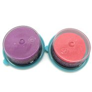 Kinetic Sand containers bottoms, showing pink and purple sand