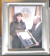Helena Cain receiving an award