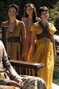 The differences in the Sand Snakes' personalities again seen in their formal wear: Nymeria is the most refined and calculating, so she wears the formal dress of a Dornish noblewoman (which is still relatively revealing); Tyene is more impulsive/aggressive but still flirtatious, so she wears the same Dornish dress, but with an X-shaped piece of leather armor straps on the front; Obara, the most martial of the sisters, outright wears typically male clothing.