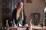 Cersei continues to wear mourning clothes into Season 5, following her father Tywin's death in the Season 4 finale.