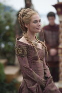 Cersei's dress at Joffrey's wedding is more subdued than usual, with more muted colors. This is to symbolize how her power will wane when Margaery becomes the new queen - but it also features symbols of power such as embroidered Lannister lions and armor-like features.