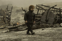 Tyrion surveys the ashes.