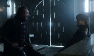Yoren and Tyrion Lannister talking in the dining hall of Castle Black.