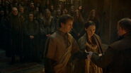 Edmure and Roslin join hands, around which the septon begins wrapping a ribbon.