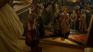 Joffrey presents Sansa to the groom because her father is dead, claiming he can stand in for him because he is king; note that Tyrion is holding a cloak.